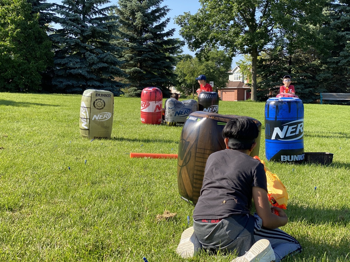 Kids in a full foam dart battle at an Ottawa park